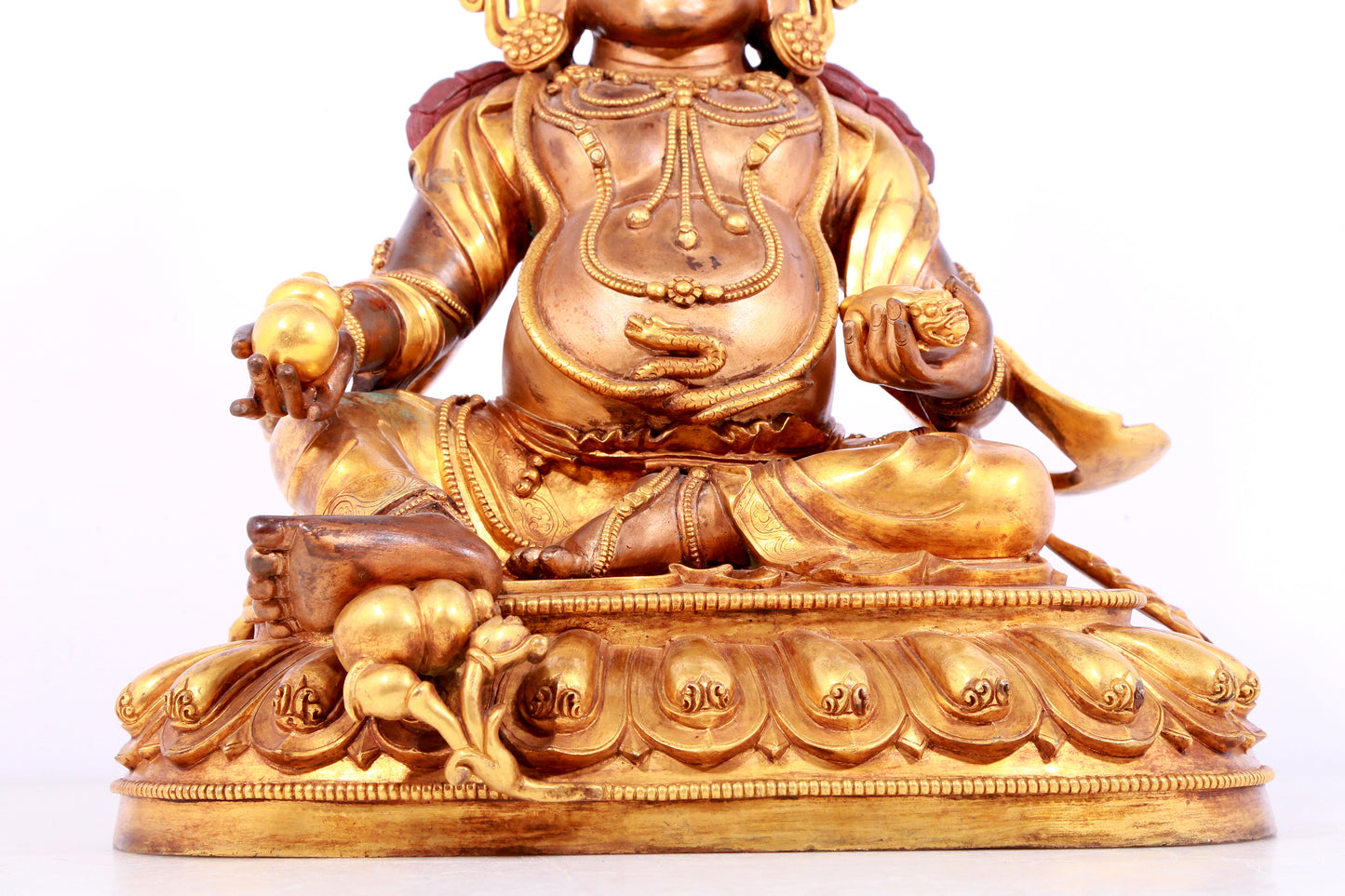 A solemn gilt bronze statue of Mammon