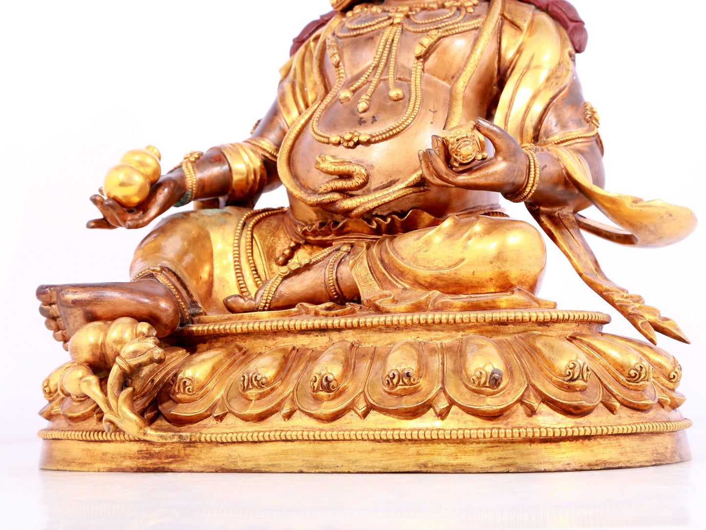 A solemn gilt bronze statue of Mammon