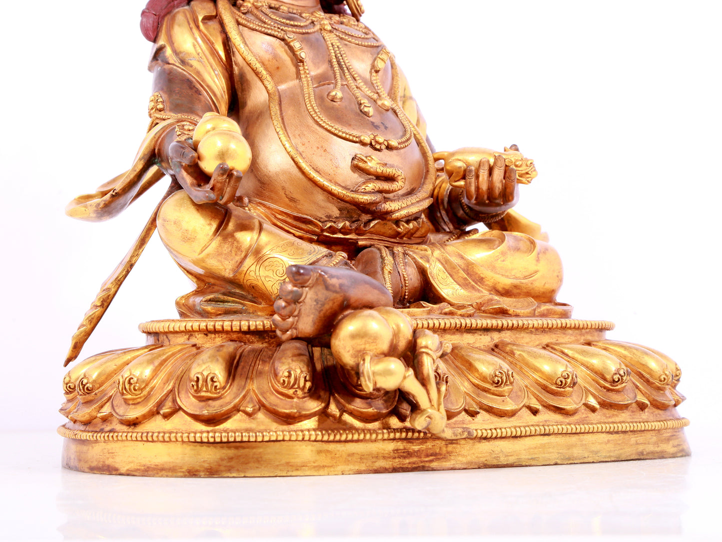 A solemn gilt bronze statue of Mammon