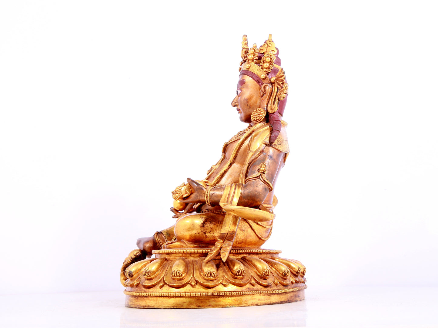 A solemn gilt bronze statue of Mammon