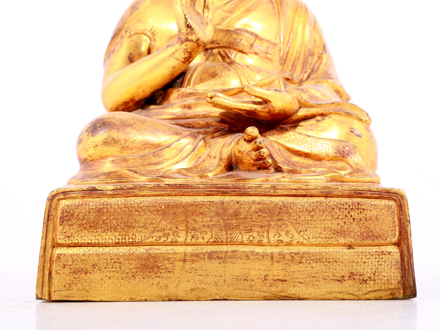 A solemn gilt bronze statue of Tsongkhapa