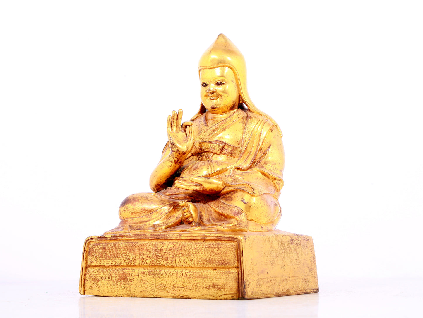 A solemn gilt bronze statue of Tsongkhapa