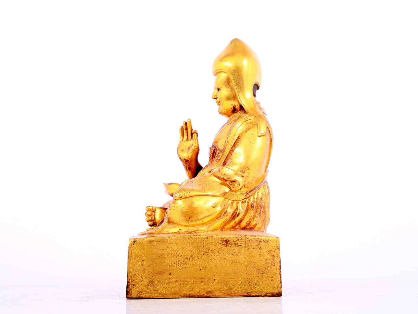 A solemn gilt bronze statue of Tsongkhapa