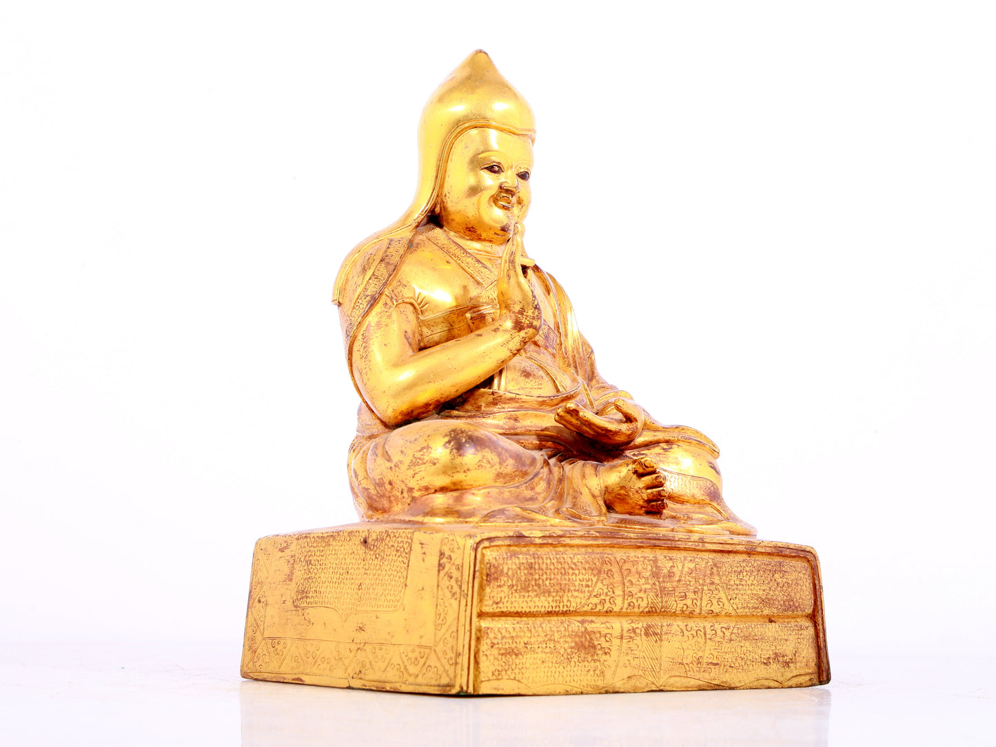 A solemn gilt bronze statue of Tsongkhapa