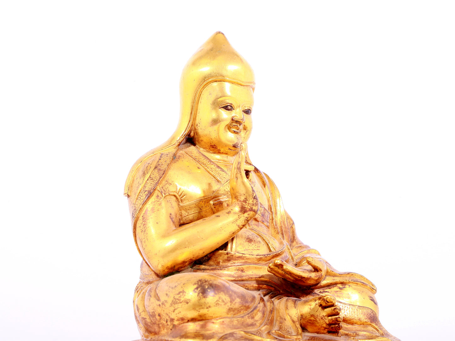 A solemn gilt bronze statue of Tsongkhapa