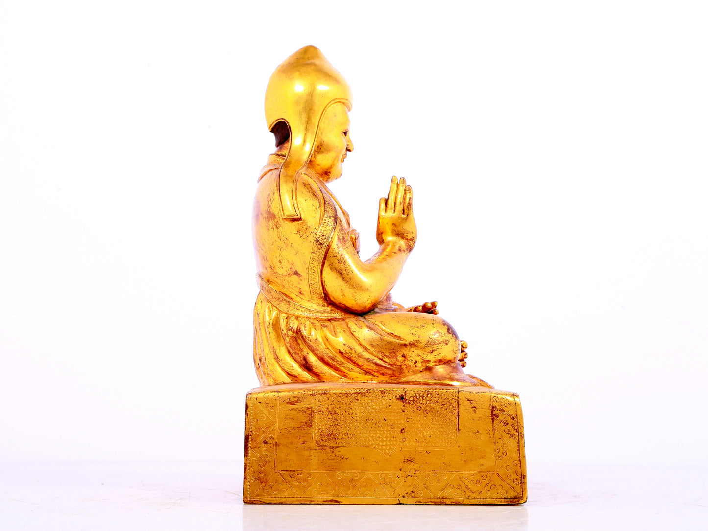 A solemn gilt bronze statue of Tsongkhapa