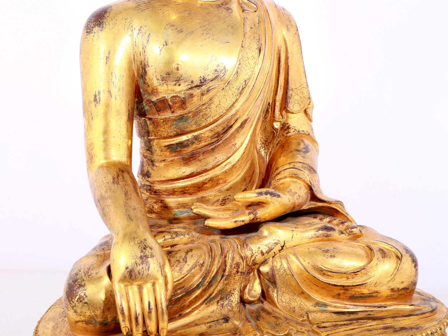 A solemn gilt bronze statue of Sakyamuni