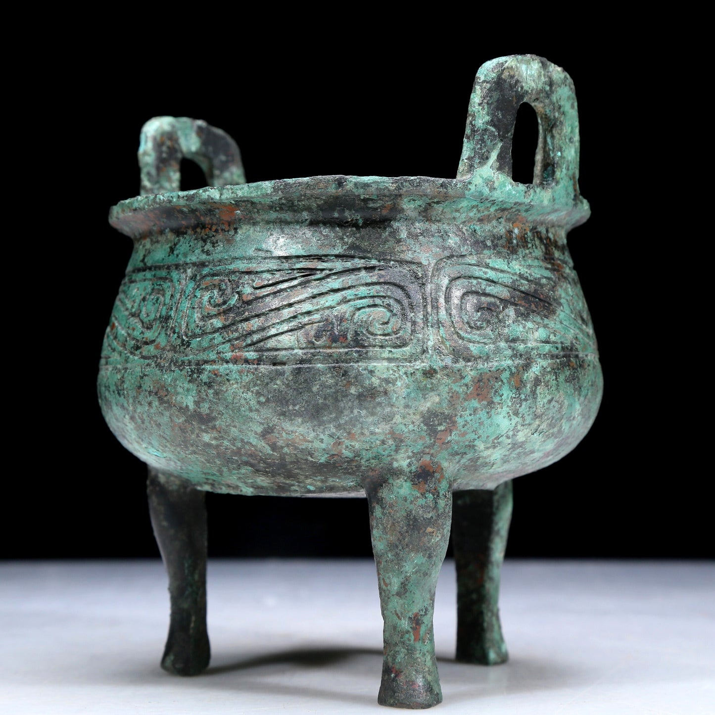 An Archaic Bronze 'Auspicious Cloud' Tripod Censer