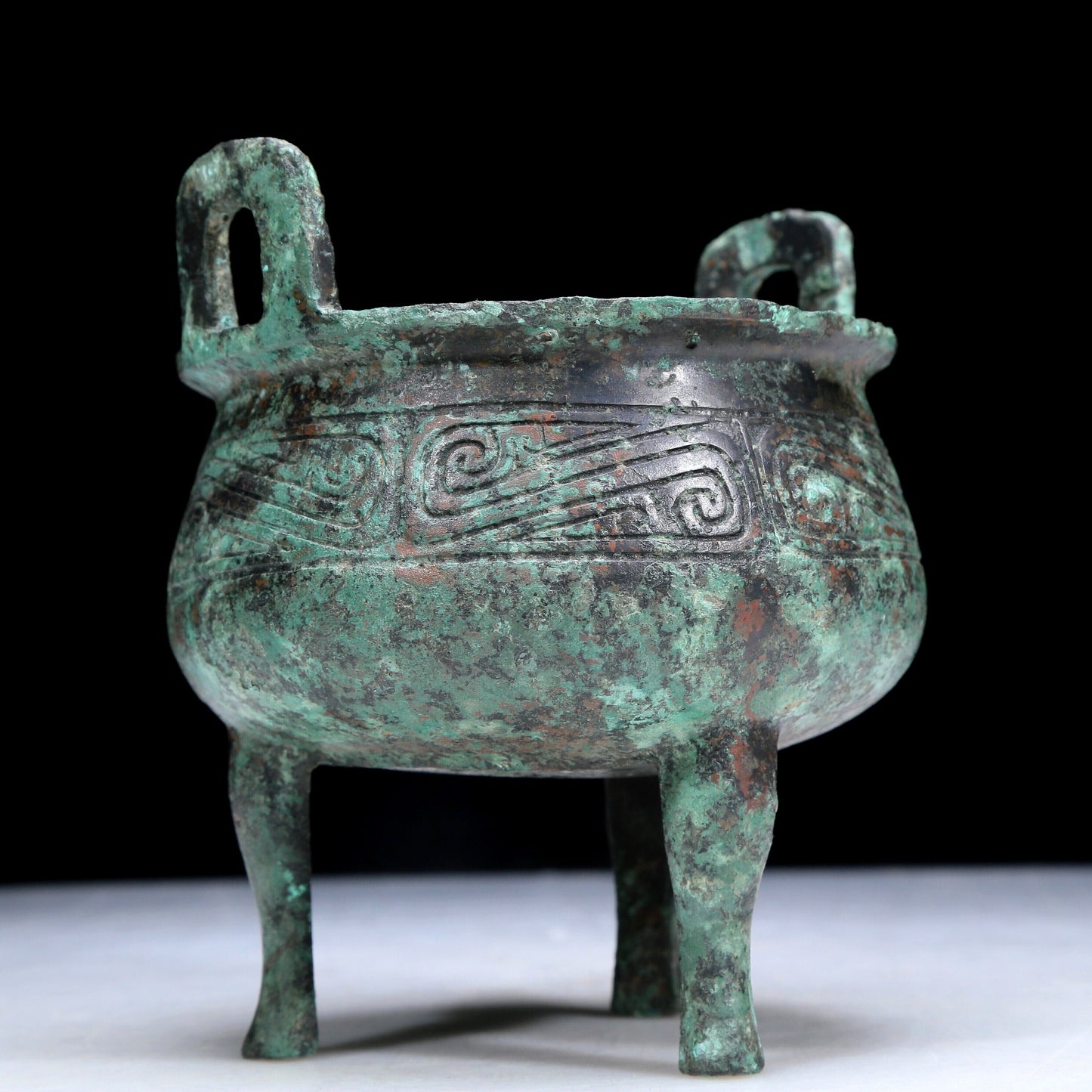 An Archaic Bronze 'Auspicious Cloud' Tripod Censer