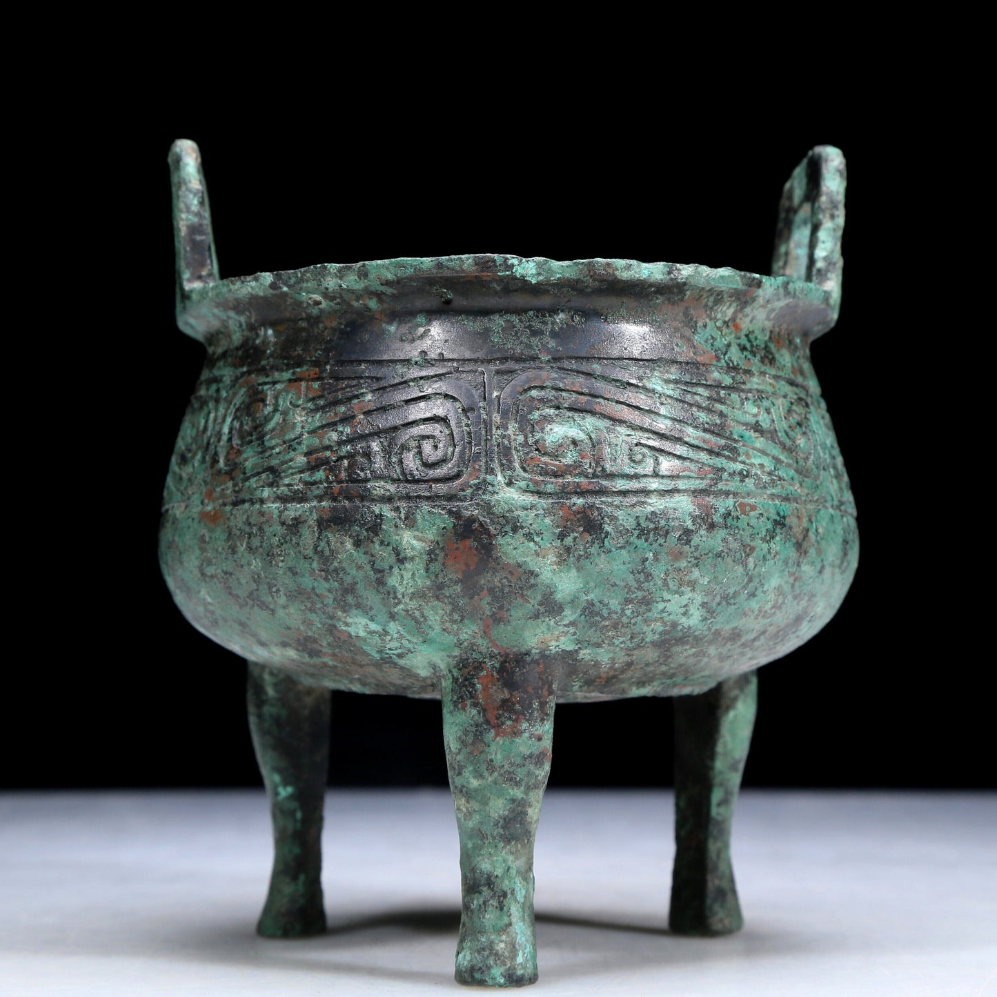 An Archaic Bronze 'Auspicious Cloud' Tripod Censer