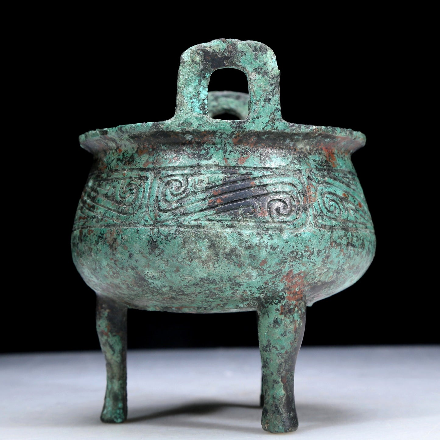 An Archaic Bronze 'Auspicious Cloud' Tripod Censer