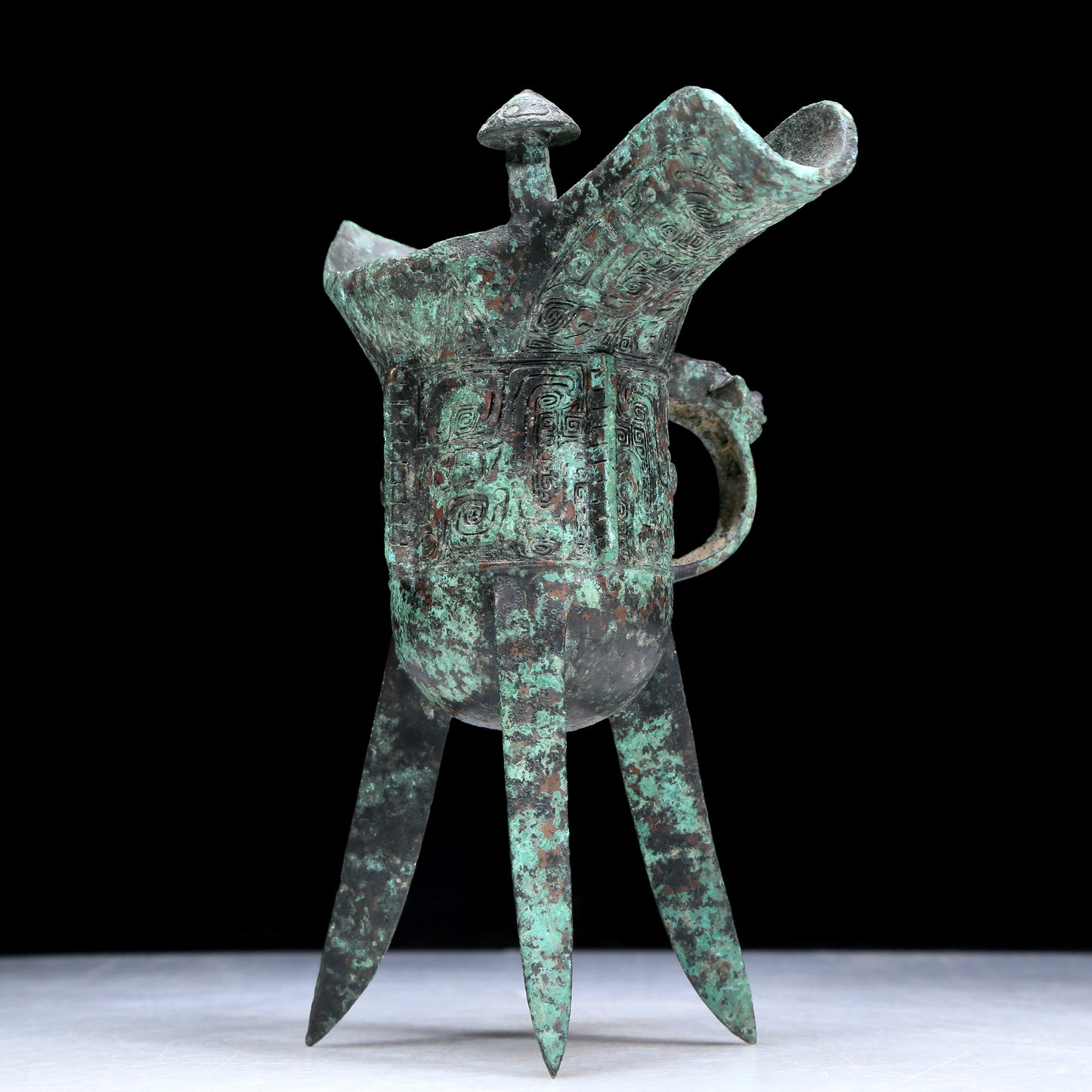 An Archaic Bronze 'Animal Mask' Tripod Cup