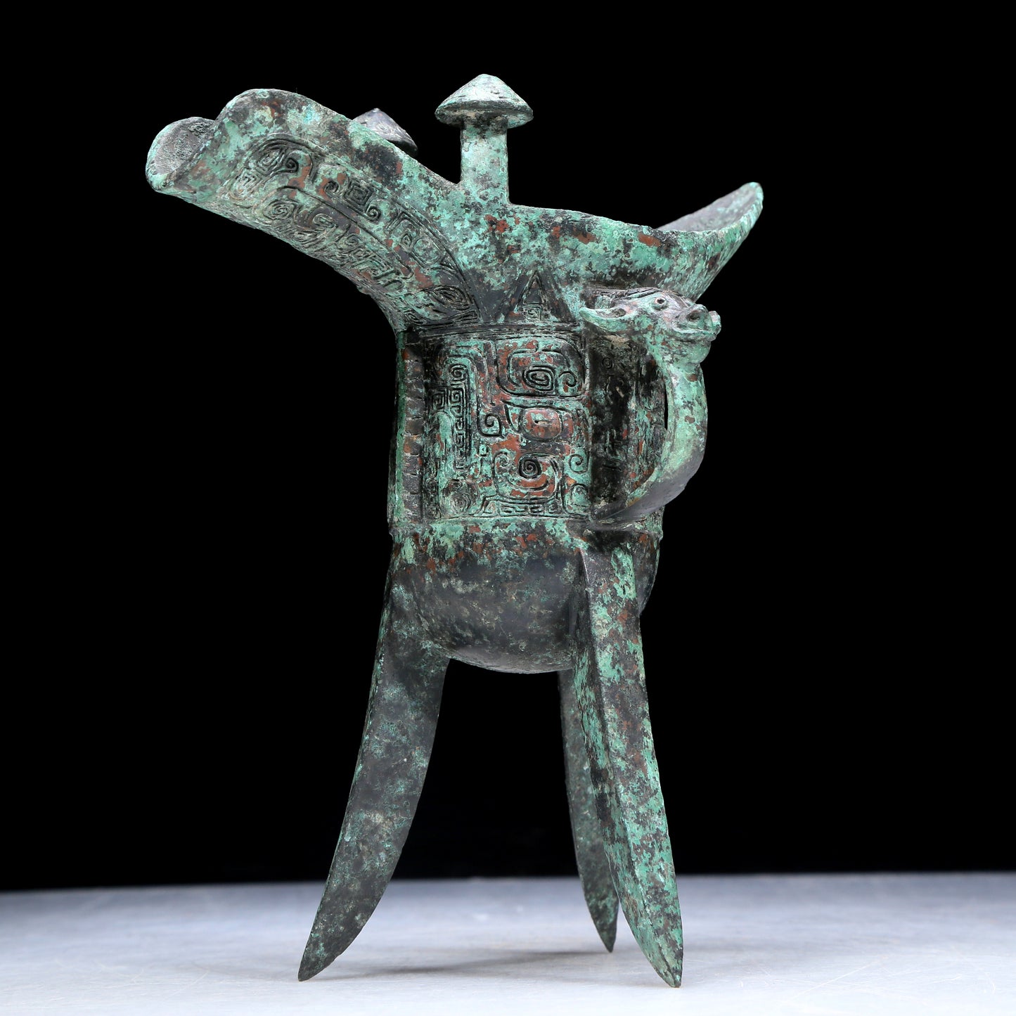 An Archaic Bronze 'Animal Mask' Tripod Cup