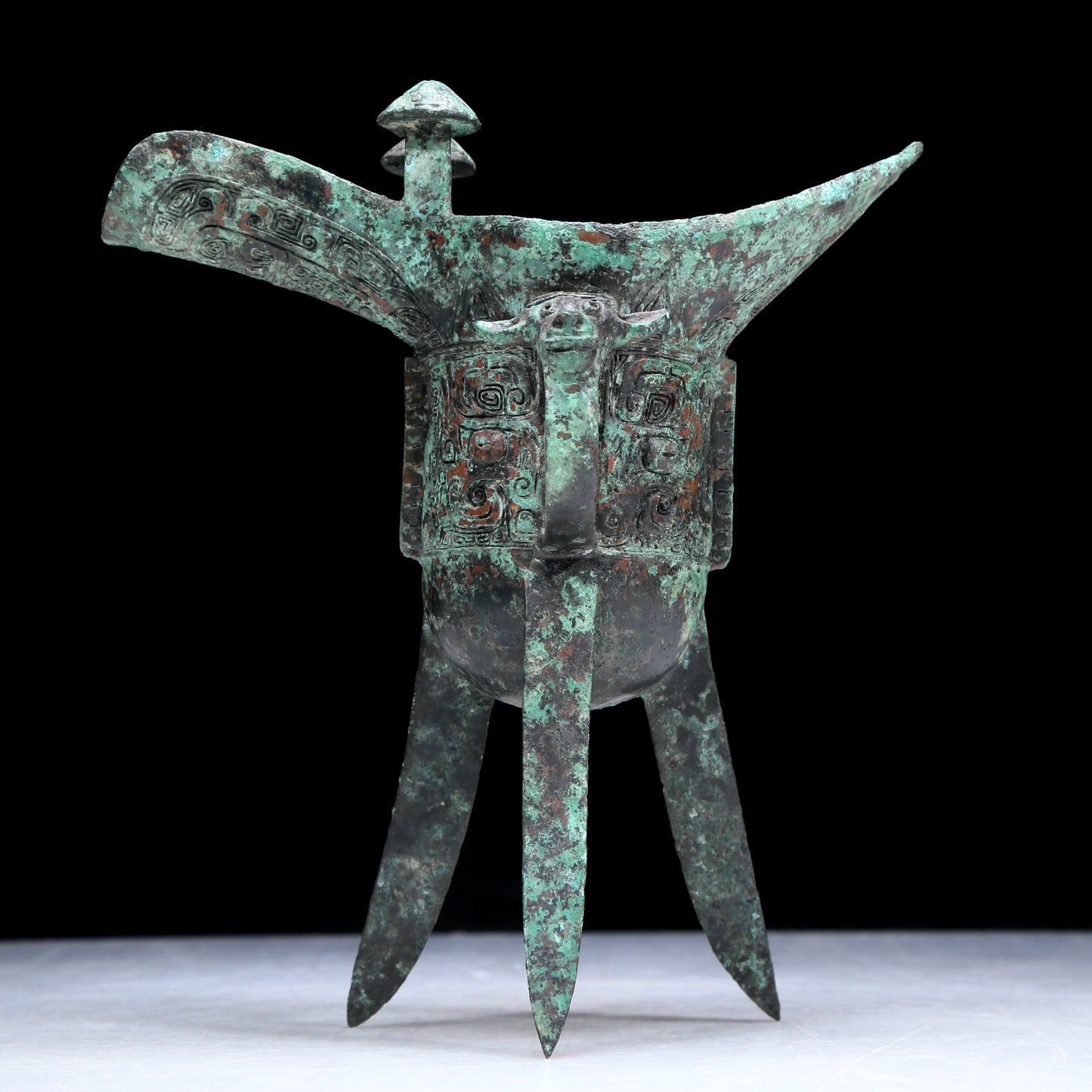 An Archaic Bronze 'Animal Mask' Tripod Cup