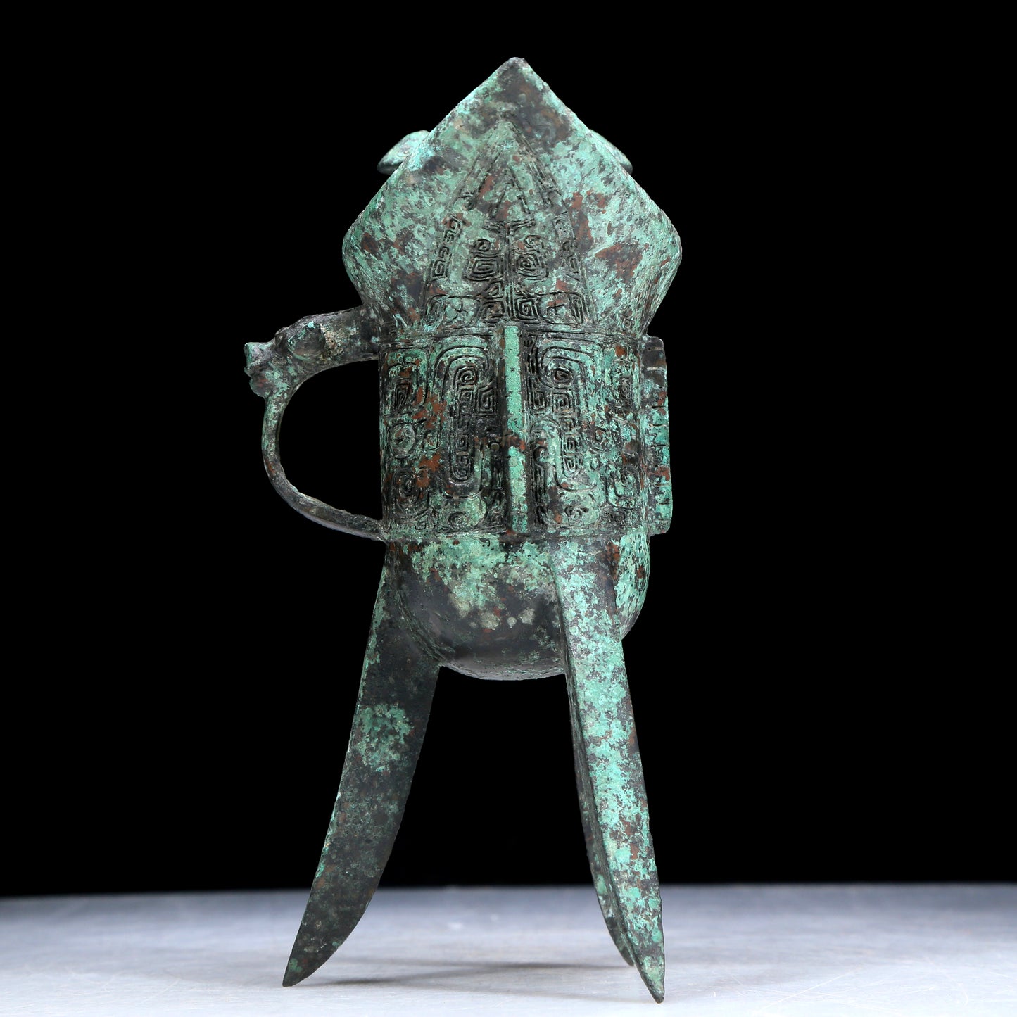An Archaic Bronze 'Animal Mask' Tripod Cup