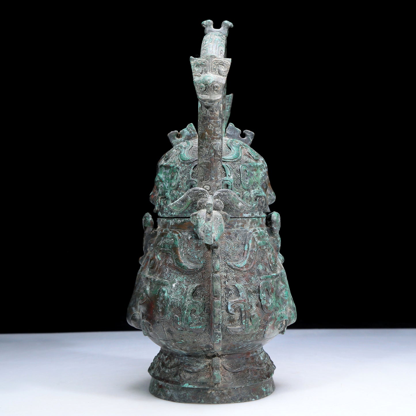 An Archaic Bronze 'Animal Mask' Pot With Inscriptions And An Overhead Handle