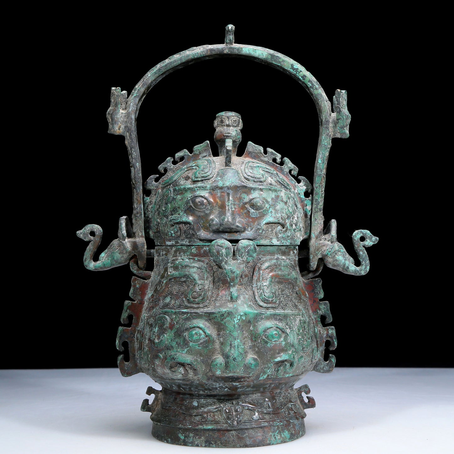 An Archaic Bronze 'Animal Mask' Pot With Inscriptions And An Overhead Handle
