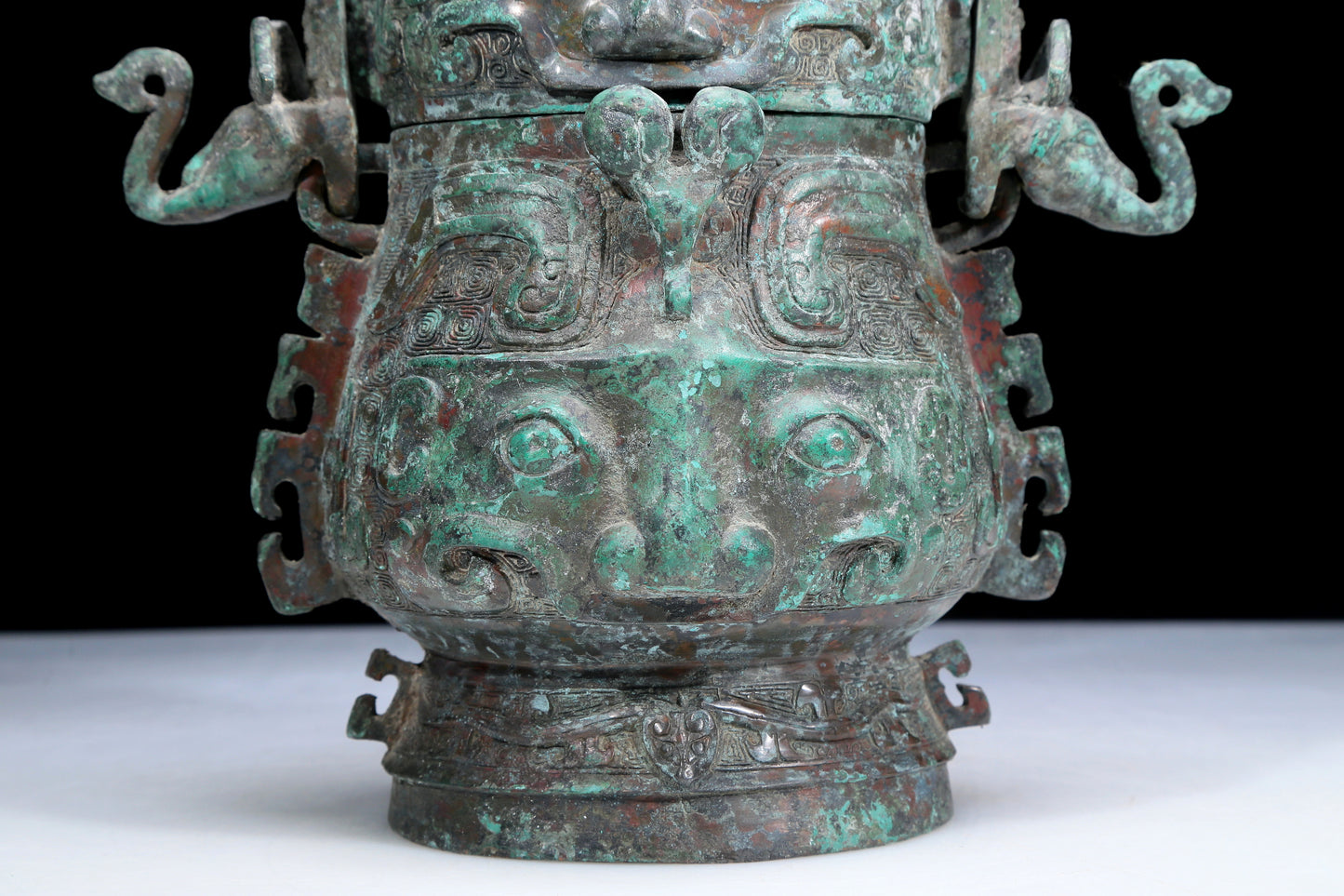 An Archaic Bronze 'Animal Mask' Pot With Inscriptions And An Overhead Handle