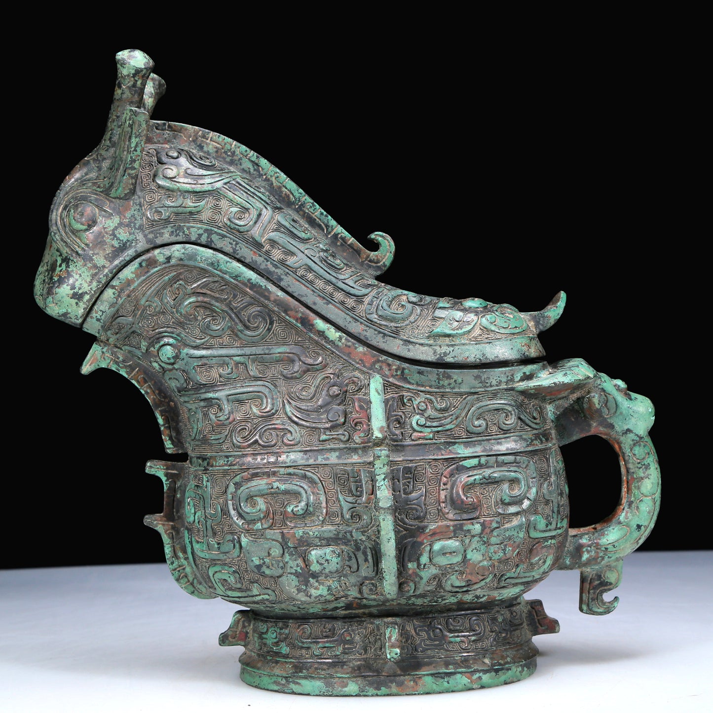 An Archaic Bronze 'Animal Mask' Ewer And Cover With Inscriptions