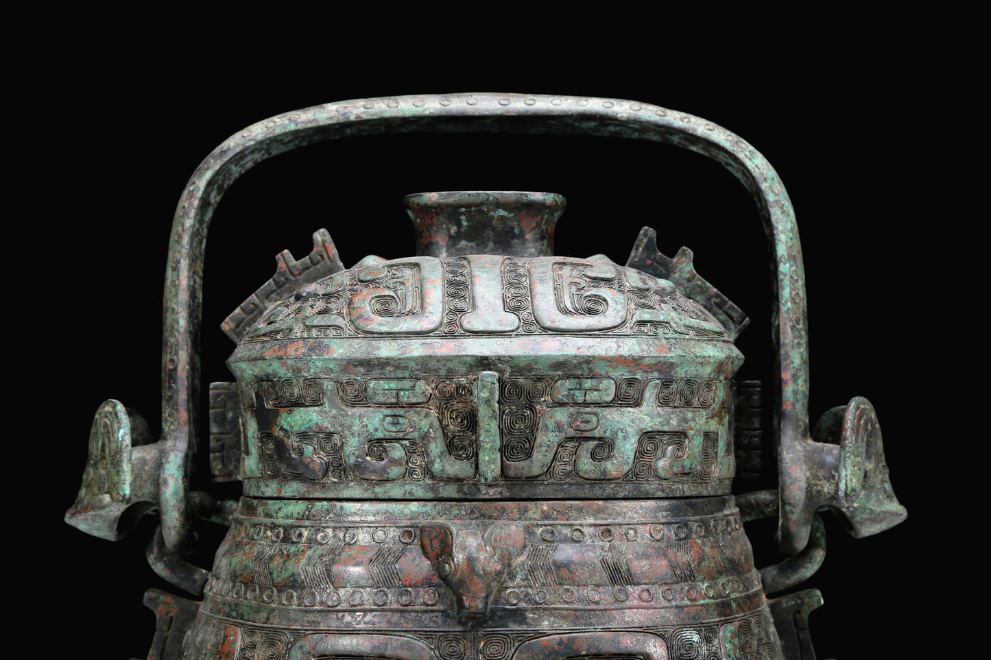 An Archaic Bronze 'Animal Mask' Pot With Inscriptions And An Overhead Handle