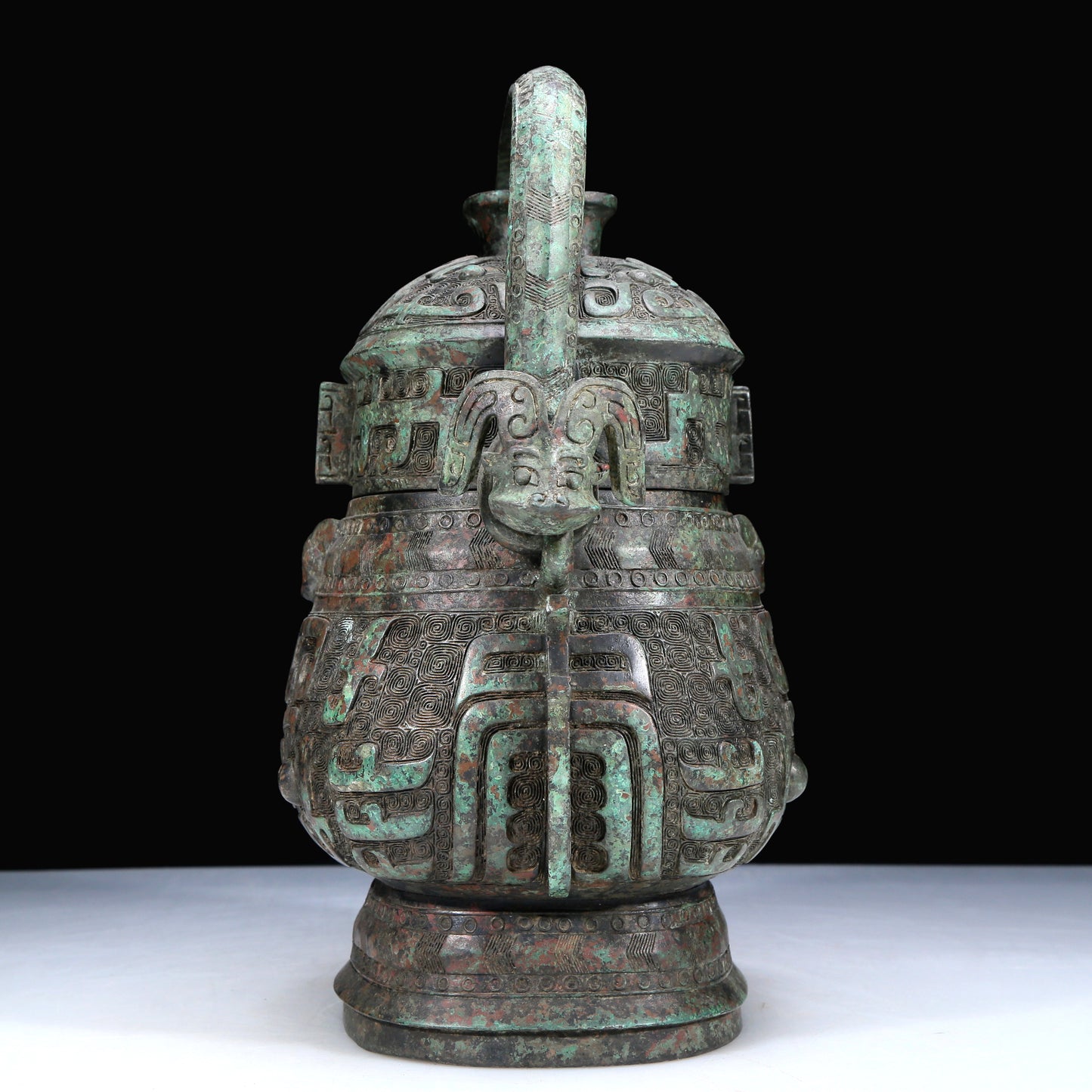An Archaic Bronze 'Animal Mask' Pot With Inscriptions And An Overhead Handle