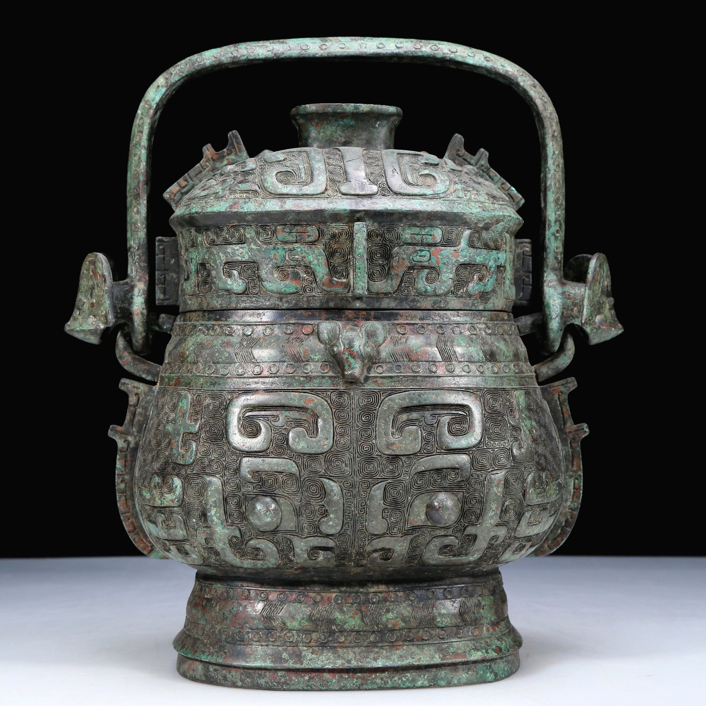 An Archaic Bronze 'Animal Mask' Pot With Inscriptions And An Overhead Handle