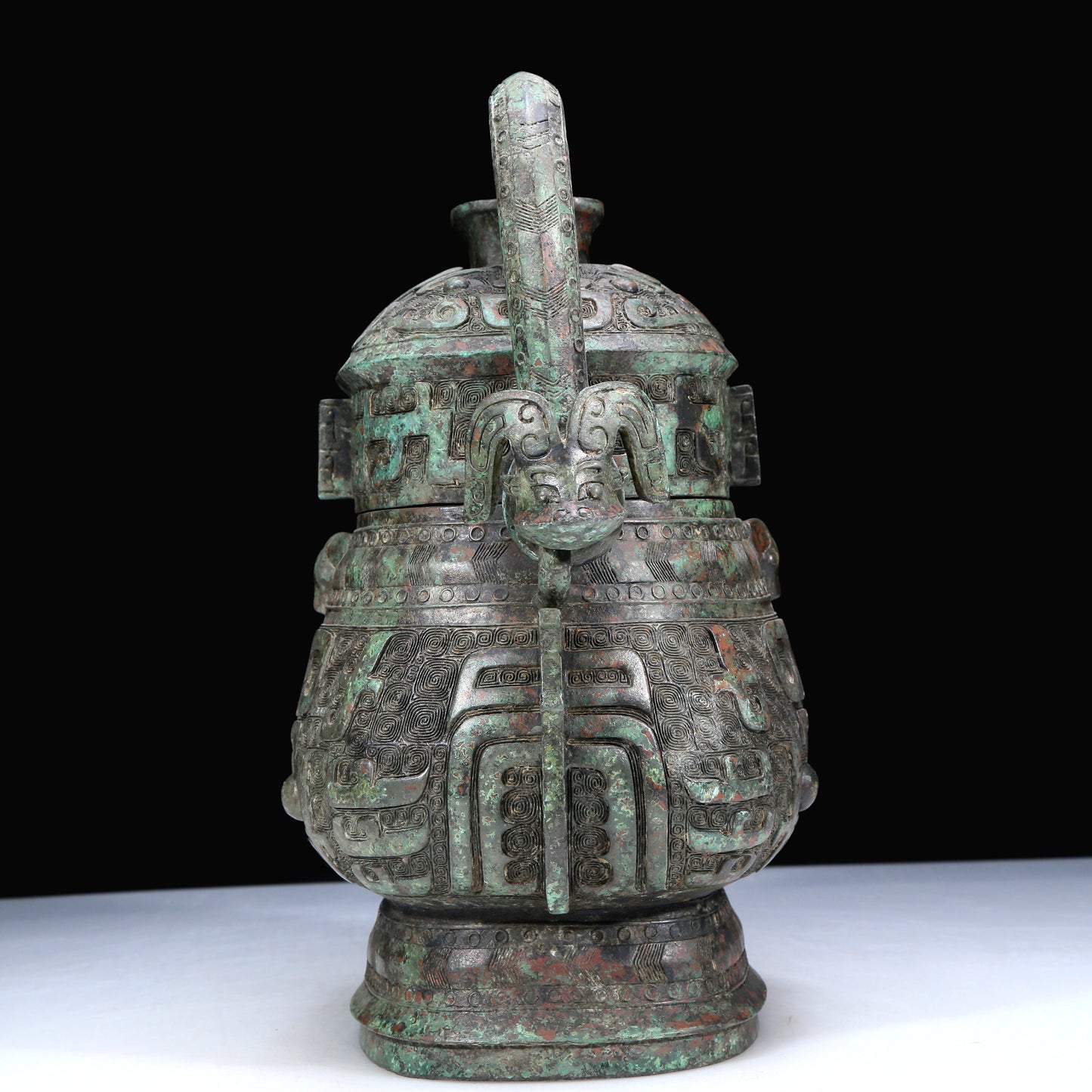 An Archaic Bronze 'Animal Mask' Pot With Inscriptions And An Overhead Handle