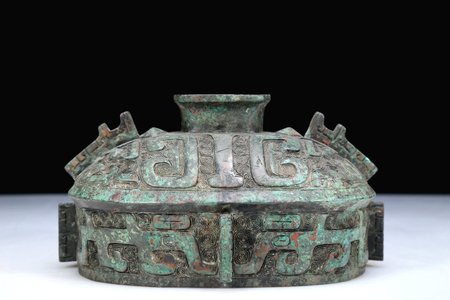 An Archaic Bronze 'Animal Mask' Pot With Inscriptions And An Overhead Handle