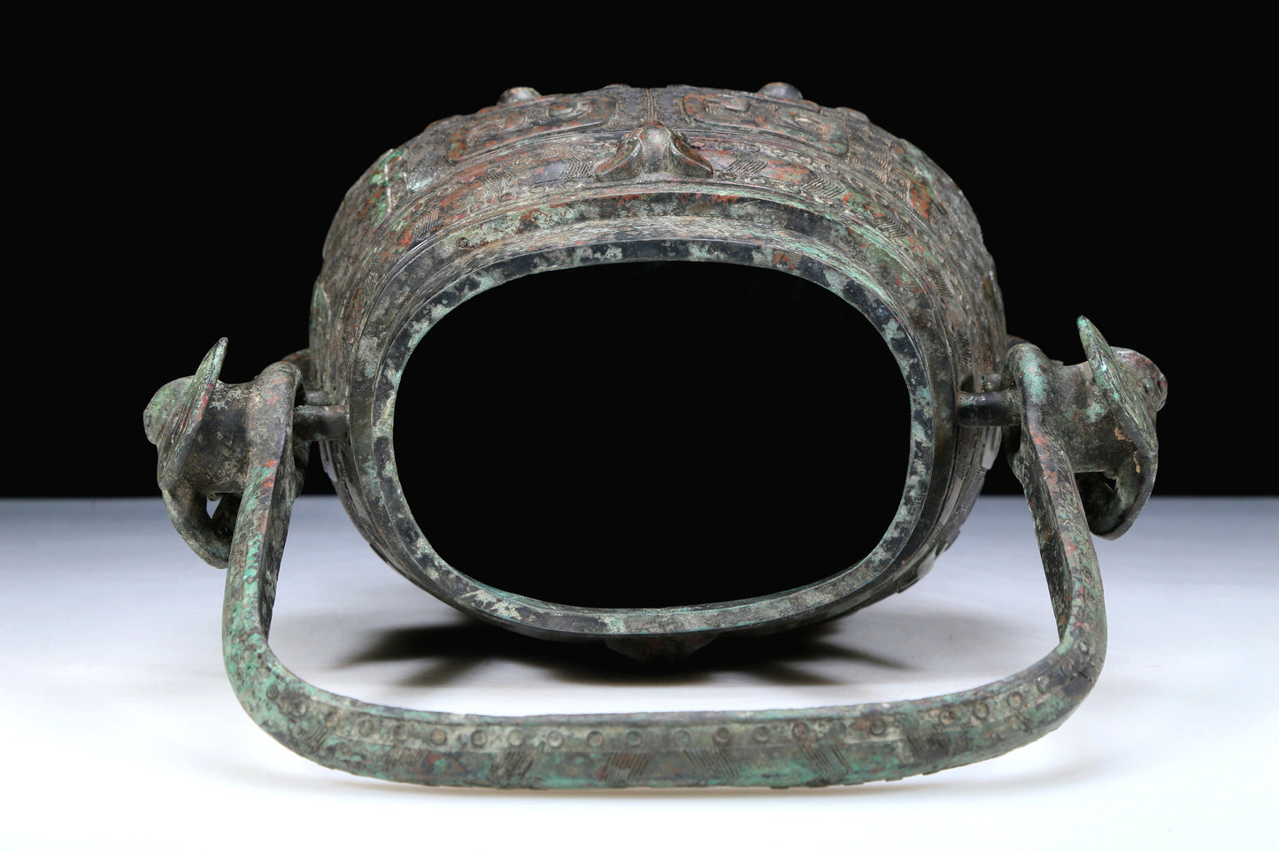 An Archaic Bronze 'Animal Mask' Pot With Inscriptions And An Overhead Handle