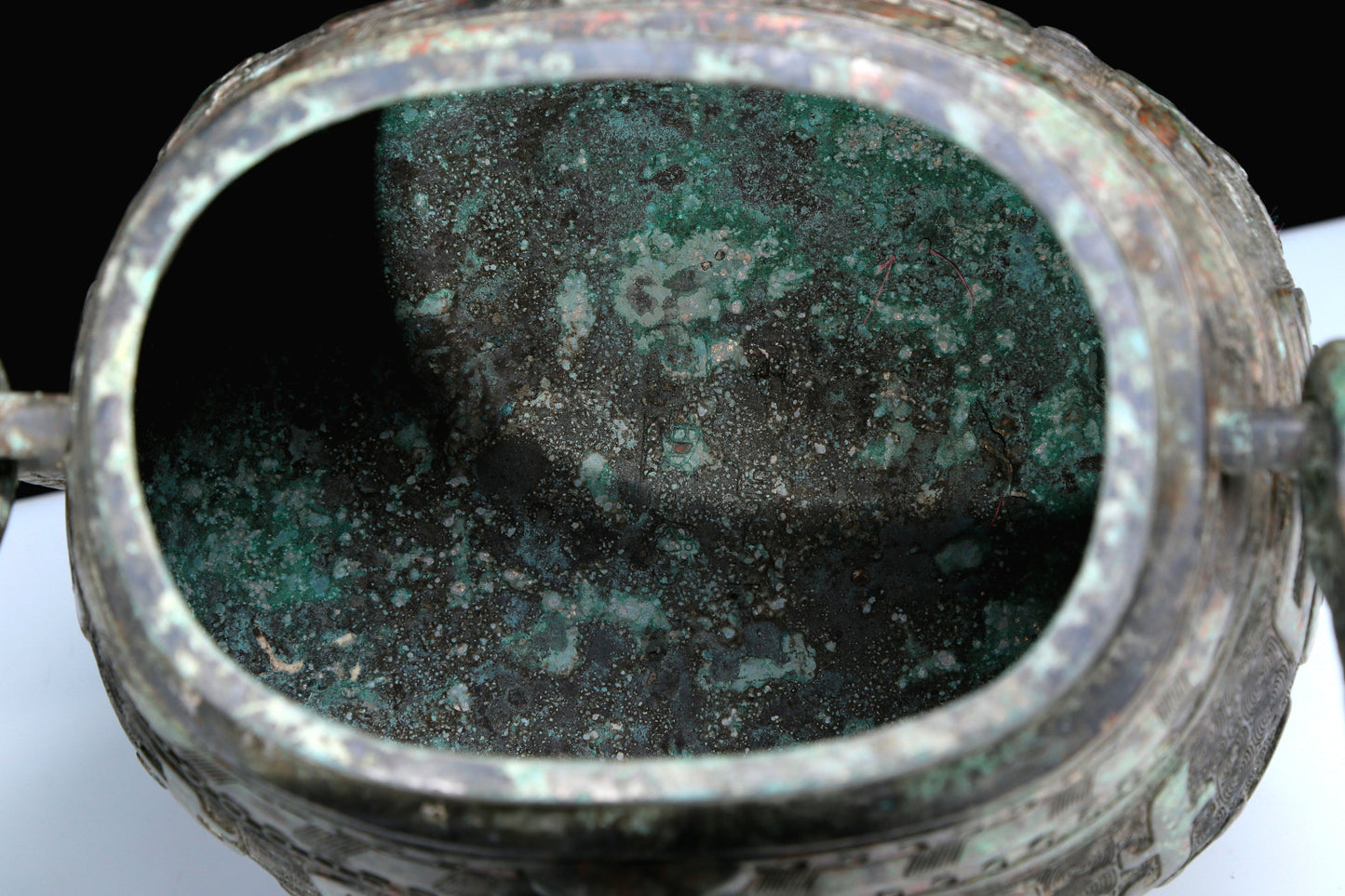 An Archaic Bronze 'Animal Mask' Pot With Inscriptions And An Overhead Handle