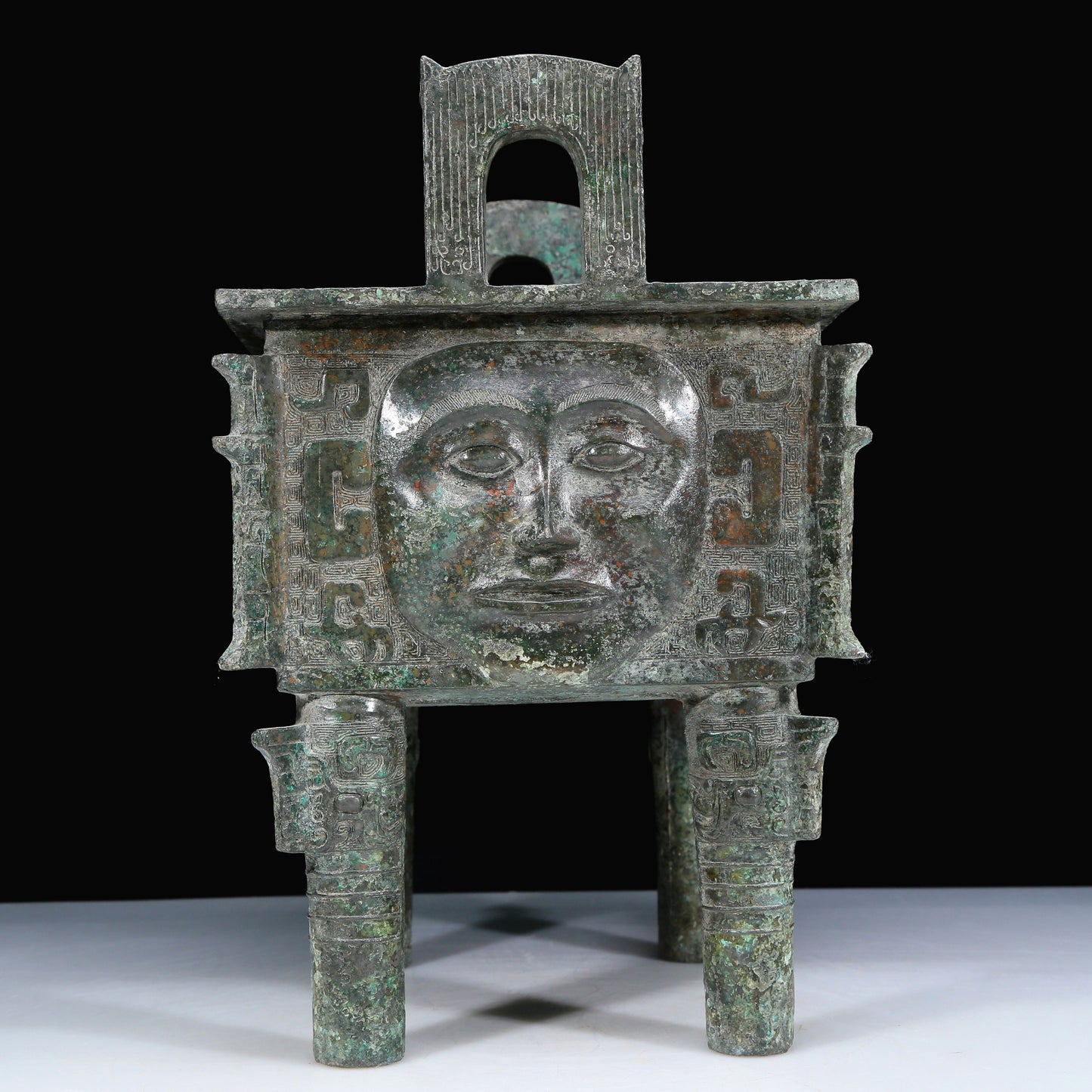 An Archaic Bronze 'Human Mask' Ritual Food Vessel, Ding