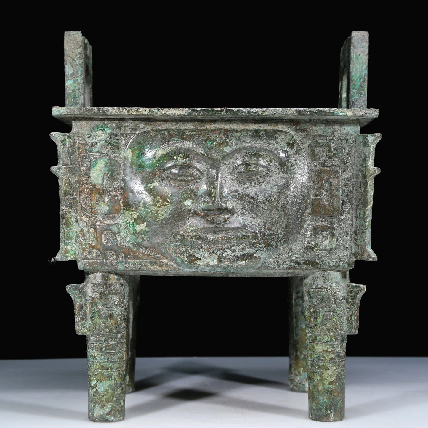 An Archaic Bronze 'Human Mask' Ritual Food Vessel, Ding