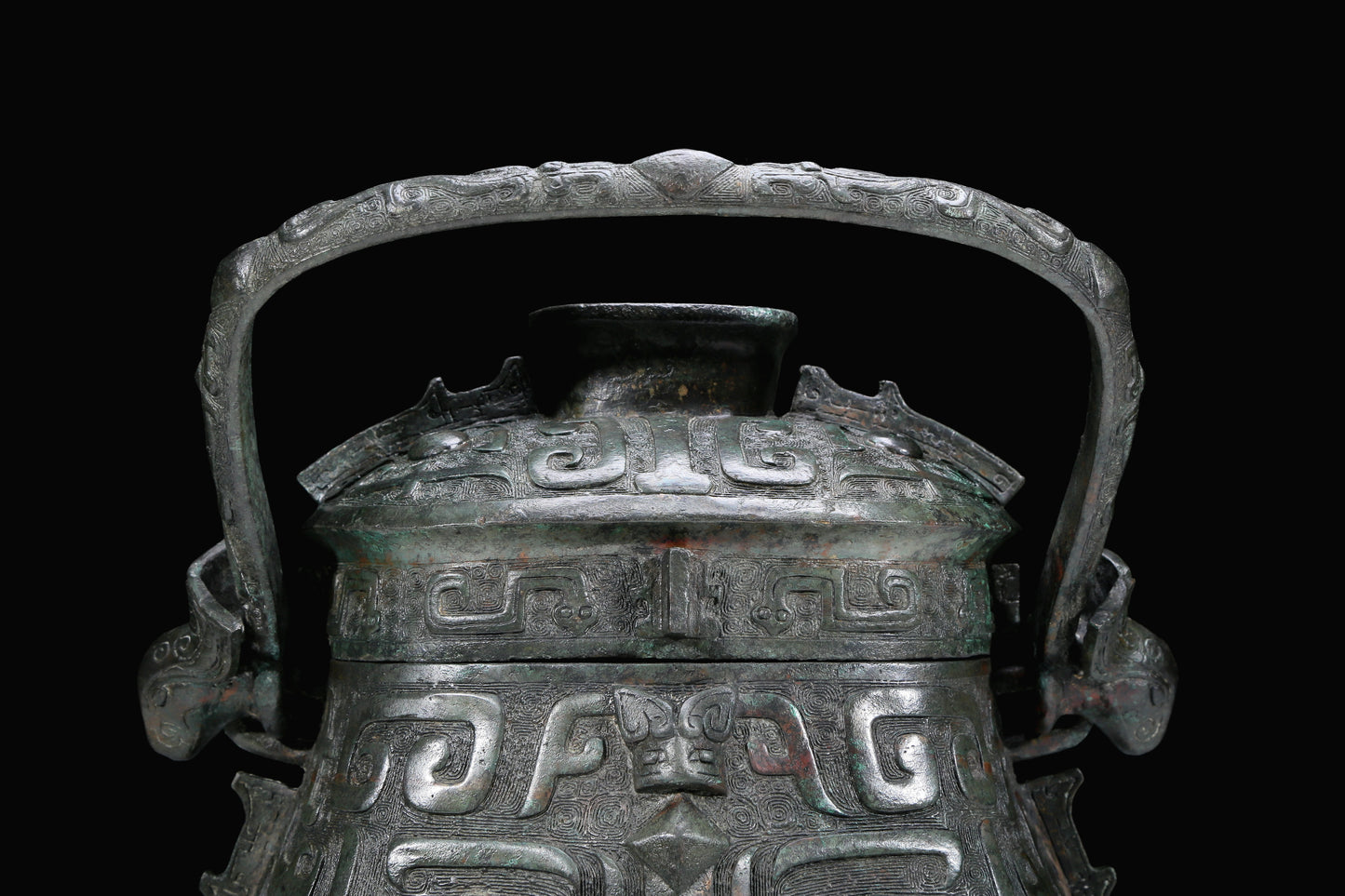 An Archaic Bronze 'Animal Mask' Pot With Inscriptions And An Overhead Handle