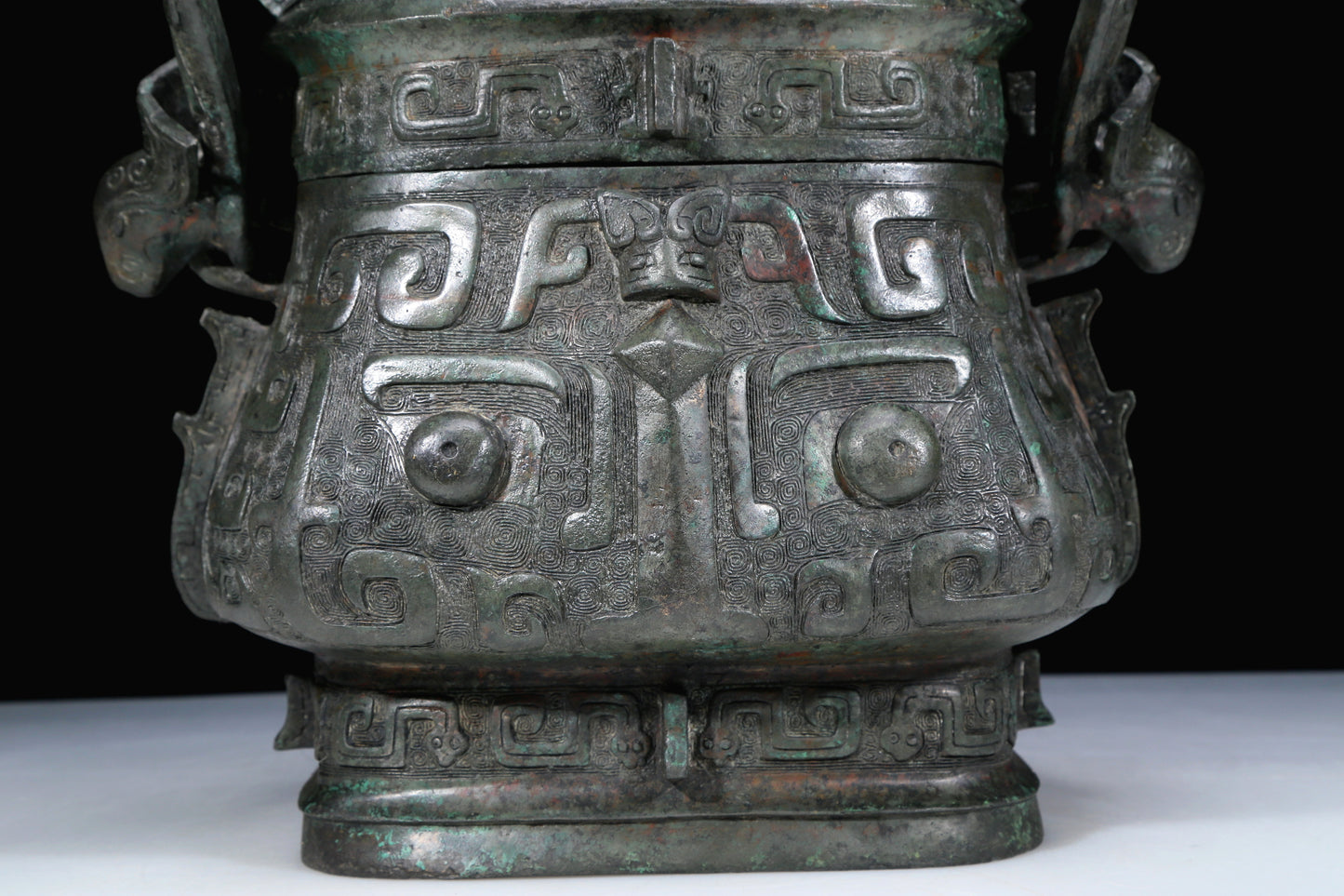 An Archaic Bronze 'Animal Mask' Pot With Inscriptions And An Overhead Handle