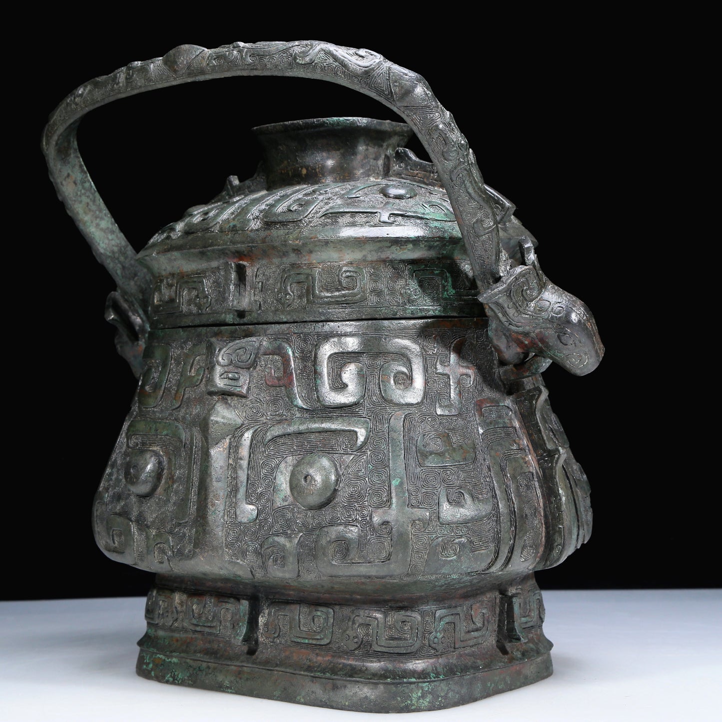 An Archaic Bronze 'Animal Mask' Pot With Inscriptions And An Overhead Handle