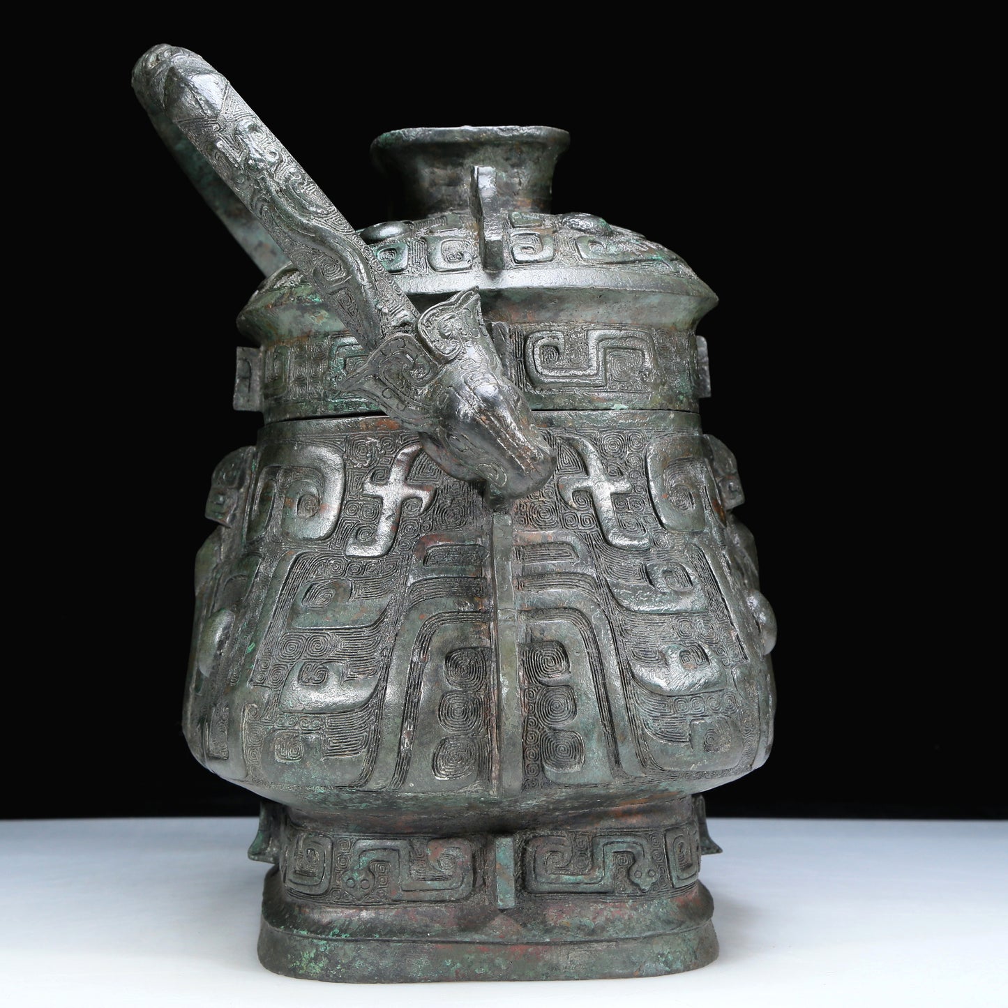 An Archaic Bronze 'Animal Mask' Pot With Inscriptions And An Overhead Handle