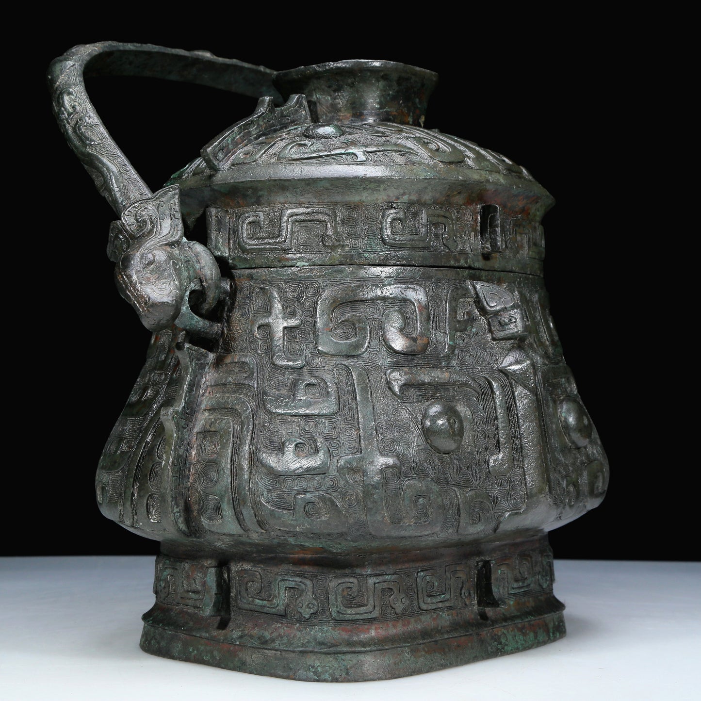 An Archaic Bronze 'Animal Mask' Pot With Inscriptions And An Overhead Handle