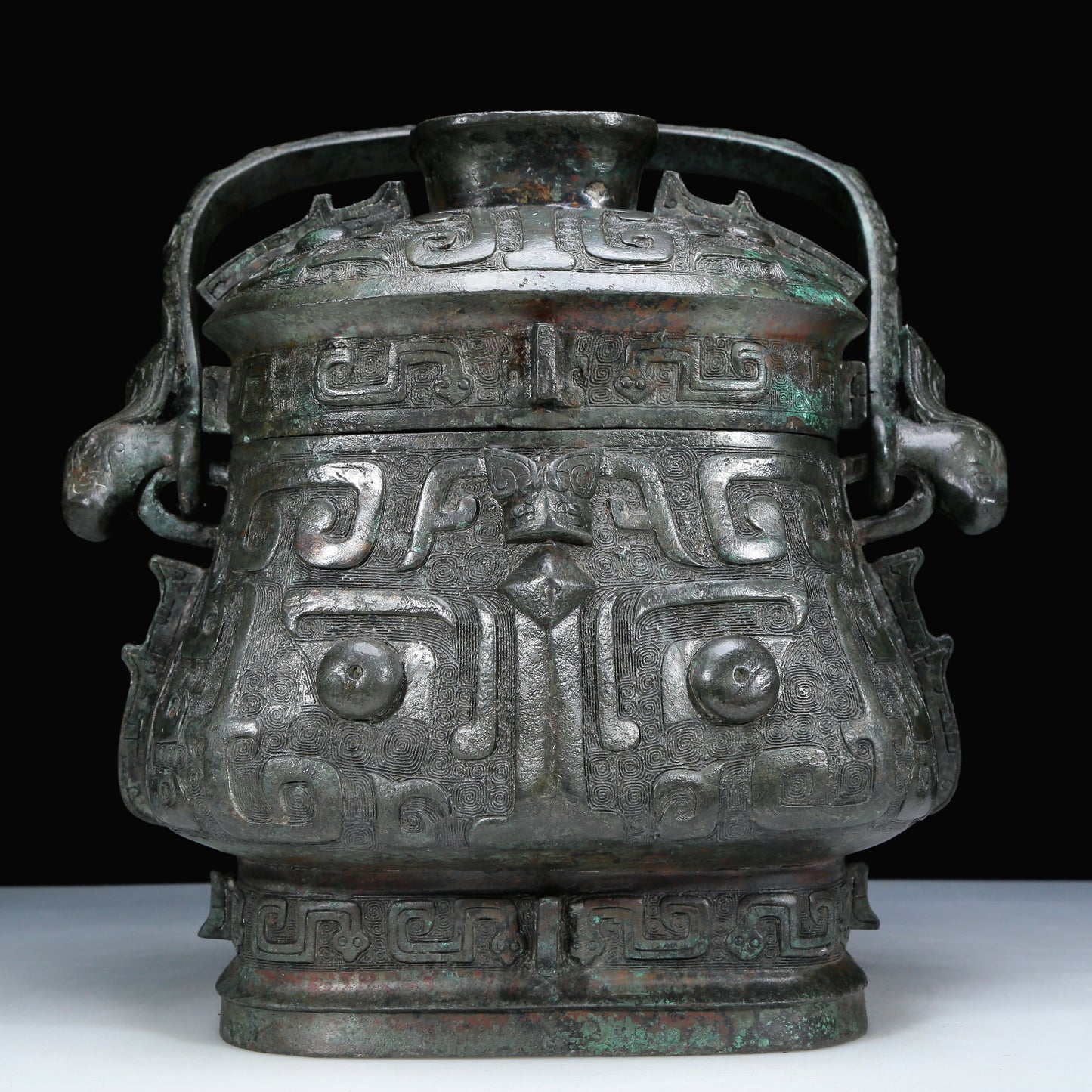 An Archaic Bronze 'Animal Mask' Pot With Inscriptions And An Overhead Handle