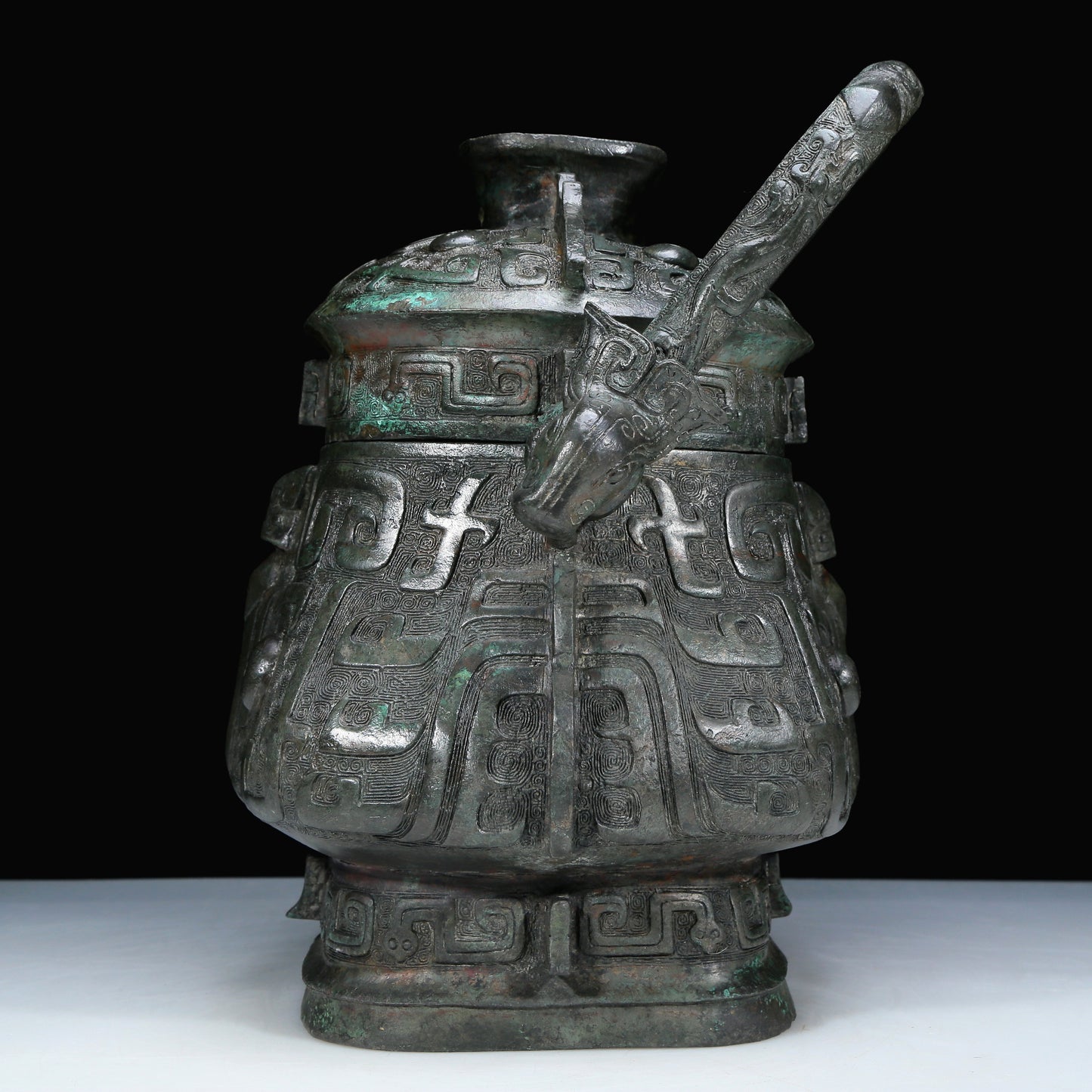 An Archaic Bronze 'Animal Mask' Pot With Inscriptions And An Overhead Handle