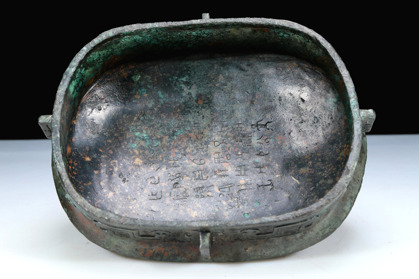 An Archaic Bronze 'Animal Mask' Pot With Inscriptions And An Overhead Handle
