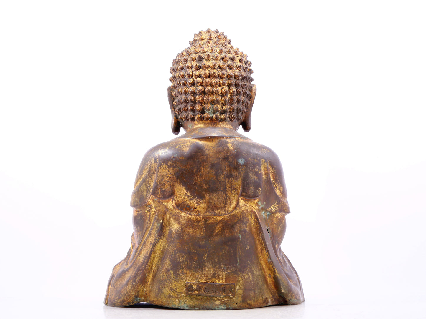 A solemn gilt bronze statue of Gautama Buddha