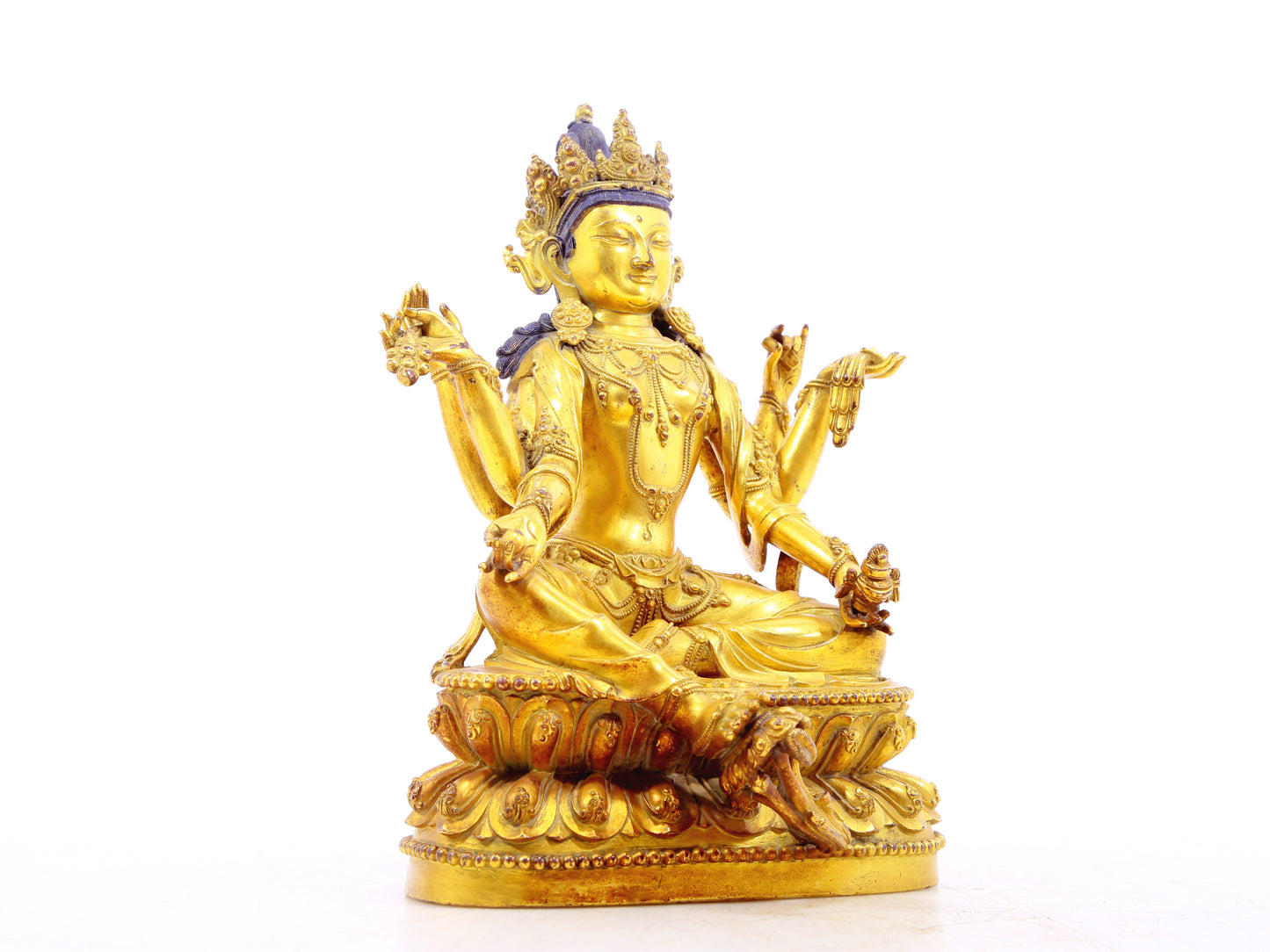 A solemn gilt bronze six-armed Guanyin statue
