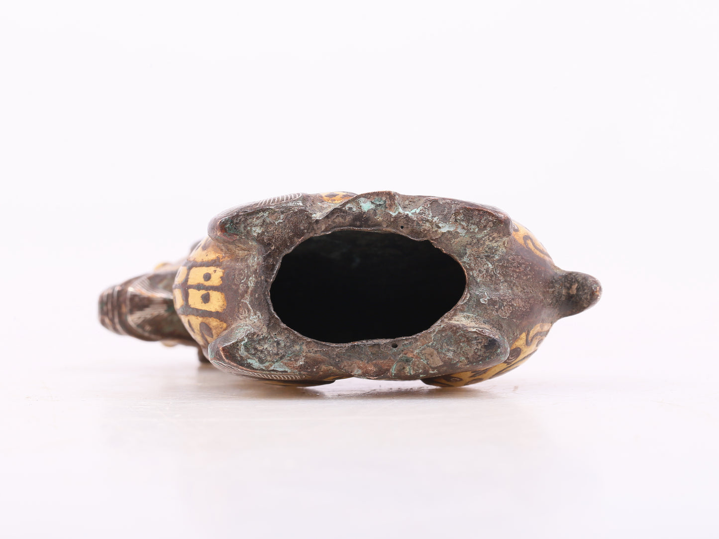 A pair of bronze inlaid gold and silver goat ornaments