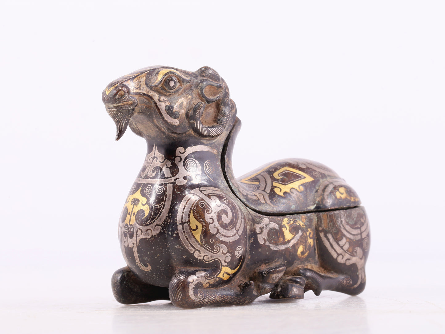 An Archaic Bronze Gold& Silver-Mounted Ram-Form Candlestick