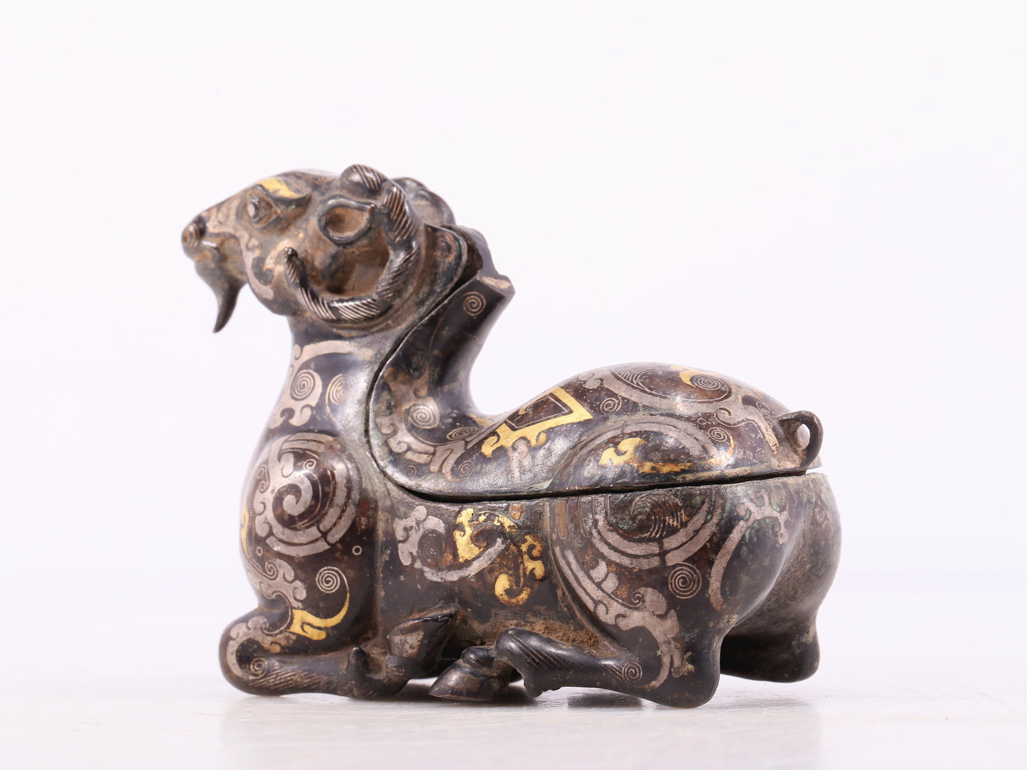 An Archaic Bronze Gold& Silver-Mounted Ram-Form Candlestick
