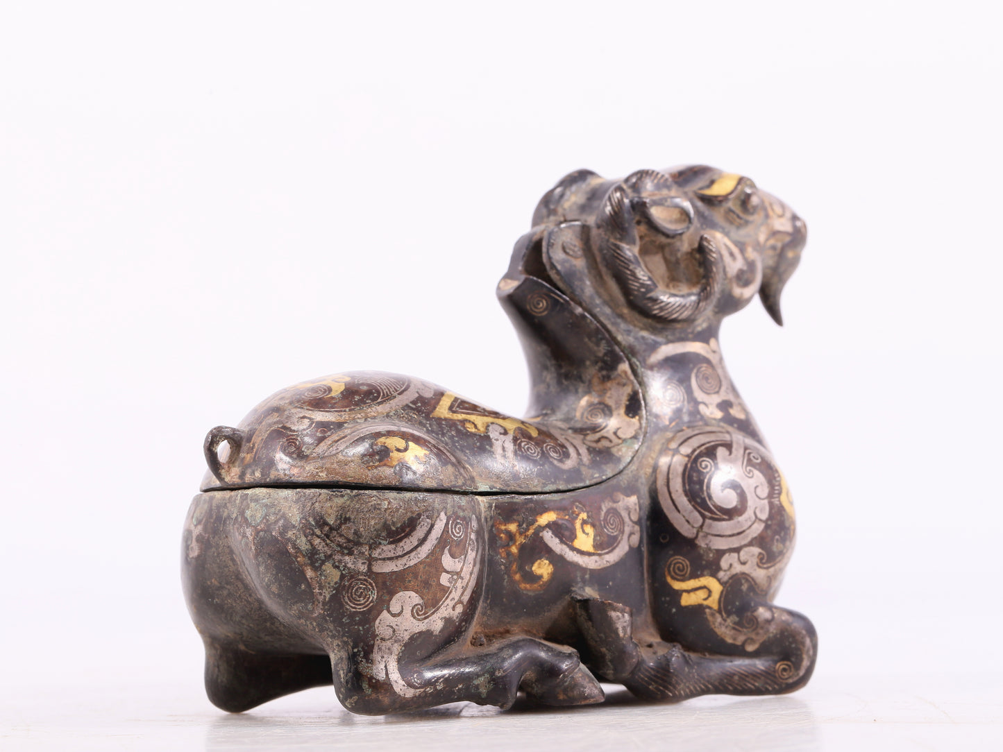 An Archaic Bronze Gold& Silver-Mounted Ram-Form Candlestick