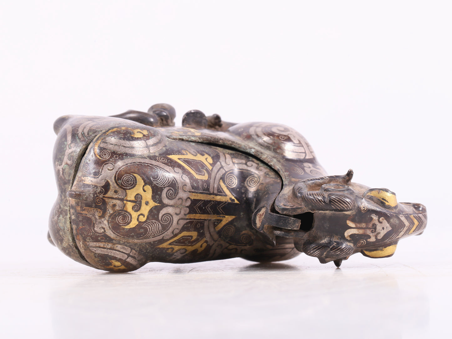 An Archaic Bronze Gold& Silver-Mounted Ram-Form Candlestick