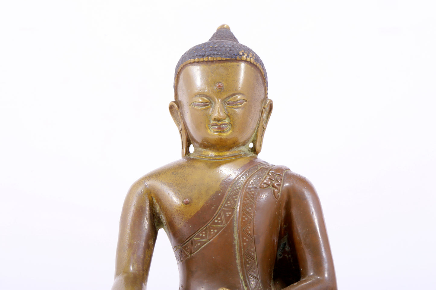A solemn alloy copper statue of Gautama Buddha