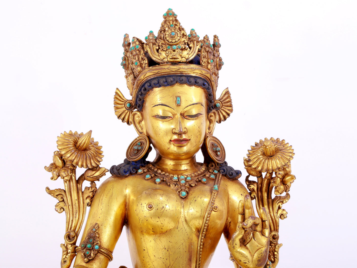 A solemn gilt copper inlaid turquoise green Tara statue