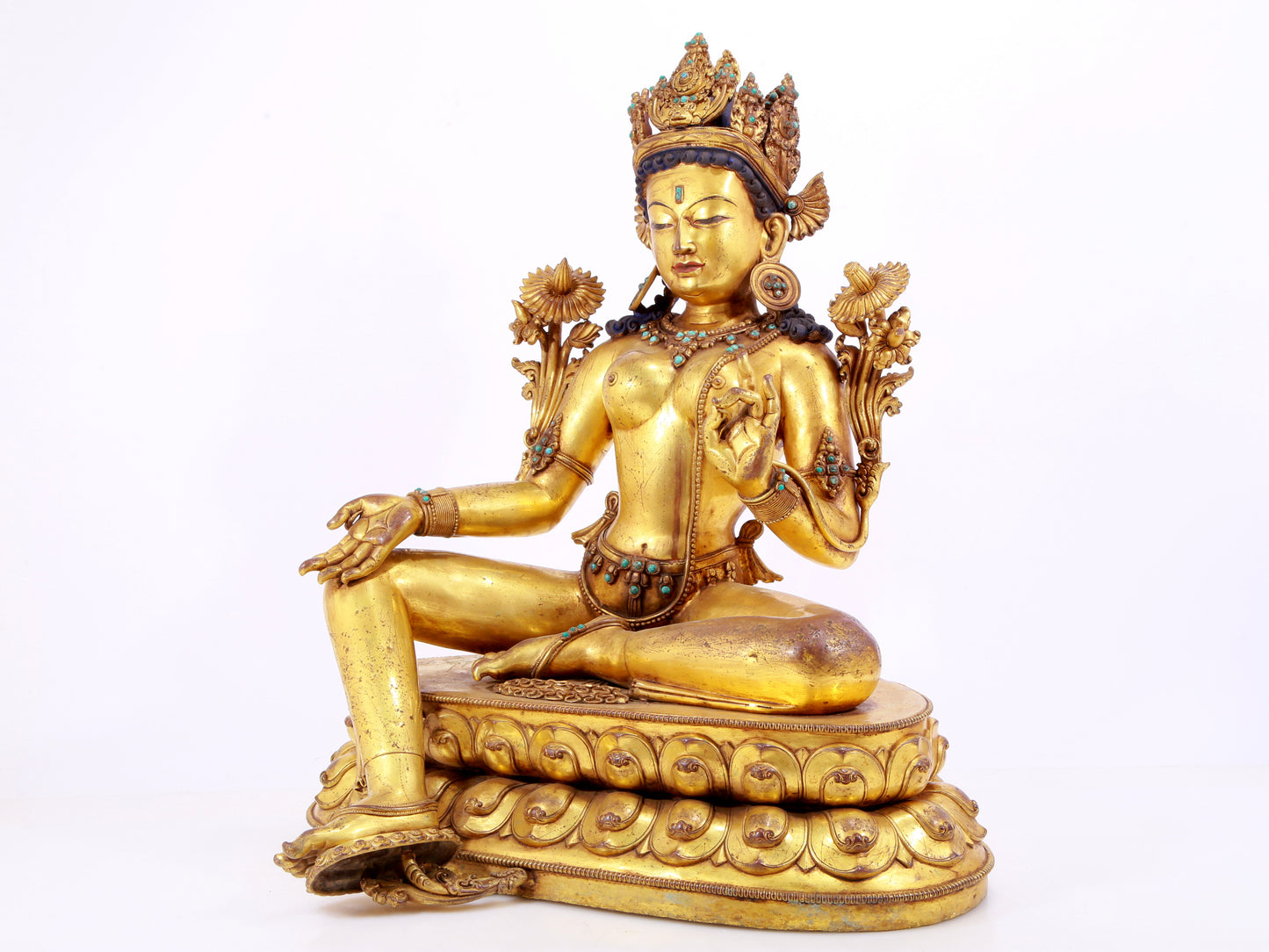 A solemn gilt copper inlaid turquoise green Tara statue
